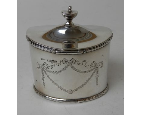 A SILVER TEA CADDY by Stokes & Ireland Limited, Chester 1911, of oval form with hinged cover and engraved ribbon and swag dec
