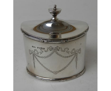 A SILVER TEA CADDY by Stokes & Ireland Limited, Chester 1911, of oval form with hinged cover and engraved ribbon and swag dec