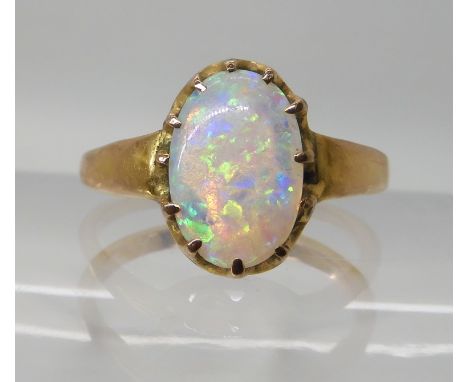 A JELLY OPAL RING set in bright yellow metal, multi claw setting, finger size O1/2, weight 3.2gms  Condition Report: It is ha