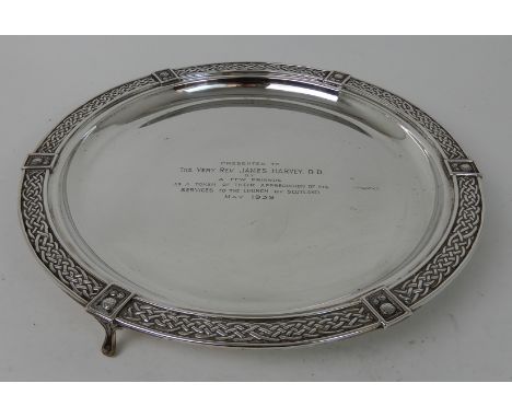 A SILVER SALVERby Brook & Son, Edinburgh 1936, or circular form, the edge with a band of Celtic decoration on three outswept 