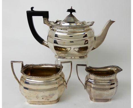 A THREE PIECE SILVER TEA SERVICE by William Aitken, Birmingham 1911, of rounded rectangular form with gadrooned border on pli