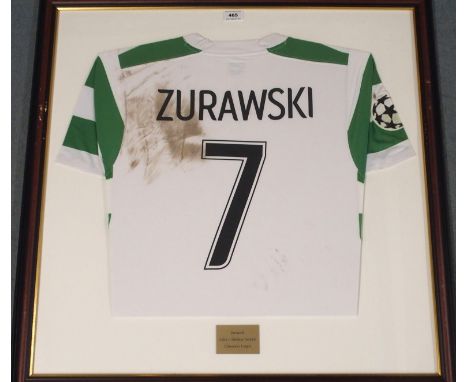 A GREEN AND WHITE CELTIC SHORT-SLEEVED SHIRT No.7, the reverse lettered Zurawski, with Champions League flash, framed and gla