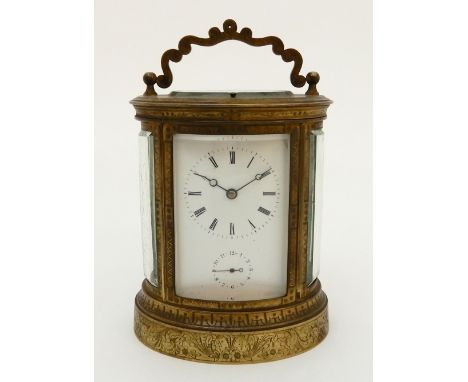 A 19TH CENTURY OVAL REPEATING CARRIAGE CLOCK striking on a bell, the white dial with Roman numerals and subsidiary alarm dial