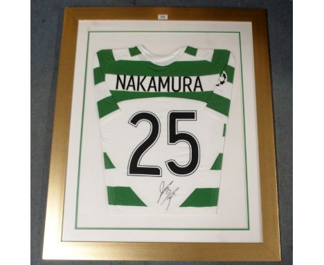 A GREEN AND WHITE CELTIC SHORT-SLEEVED SHIRT No.25, the reverse lettered Nakamura and autographed by Nakamura, one sleeve wit