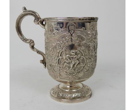 A SILVER TANKARD by James Weir, Glasgow 1891, of cylindrical form profusely embossed with putti playing instruments, flowerhe