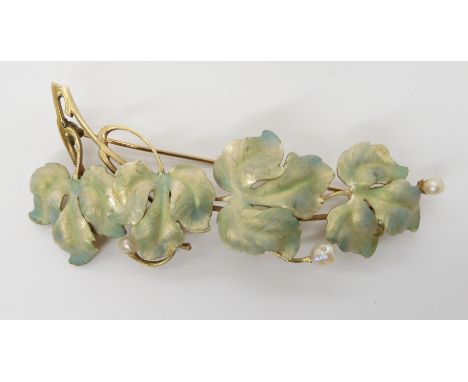 A LARGE ART NOVEAU PEARL AND ENAMEL BROOCH made in bright yellow metal, the naturalistic branch has enamelled leaves in opale