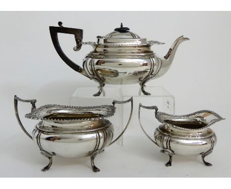 A THREE PIECE SILVER TEA SERVICE by James Deakin &amp; Son, Sheffield 1919, of rounded rectangular form with gadrooned and pi