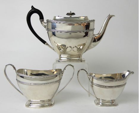 A THREE PIECE SILVER TEA SERVICE by James Ramsay, Sheffield 1917, of tapering rounded rectangular form with gadrooned banding