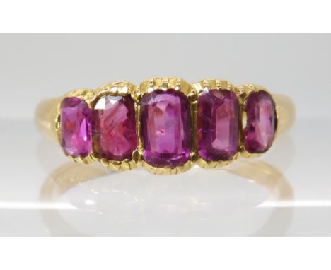 A BRIGHT YELLOW FIVE STONE RUBY RING each in a cut back clawed setting, largest ruby approx 5mm x 3.3mm x 1.9mm. Finger size 