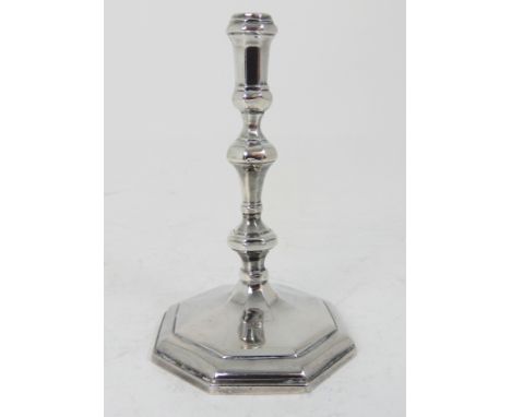 A GEORGE II SILVER TAPER STICK by William Gould, London 1750, the knopped stem with faceted shoulders on octagonal pedestal b