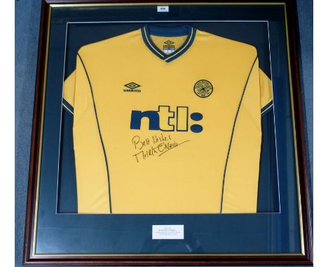 A YELLOW CELTIC SHORT-SLEEVED SHIRT autographed by Martin O'Neill, with caption stating Signed by Martin O'Neill on his first