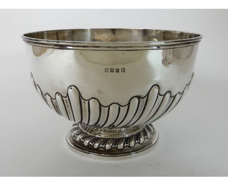 AN EDWARDIAN SILVER PUNCH BOWL by R & W Sorley, Glasgow 1905, of circular form with spiral fluted half body on circular pedes