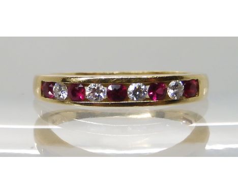 AN 18CT RUBY AND DIAMOND HALF ETERNITY RING set with estimated approx 0.20cts of brilliant cut diamonds and further set with 