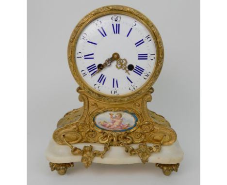 A FRENCH STYLE MANTLE CLOCK the drum head enamel dial with roman numerals, marked for G Mylne, Paris, above a Sevres style pa