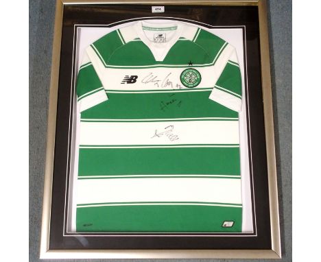 A GREEN AND WHITE REPLICA CELTIC SHORT-SLEEVED SHIRT the front of the shirt autographed by One Direction, autographed at the 