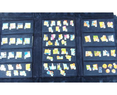A LARGE COLLECTION OF 2004 OLYMPIC ENAMEL LAPEL BADGES in blue plush folder and another example relating to the torch relay (