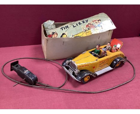 A Post War Tinplate Car - "Tin Lizzy" by Arnold of Germany, overall good with four original passengers, mechanism defective a