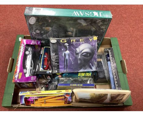 An Assorted Collection of Diecast Model Vehicles, Jigsaw Puzzles, etc. to include Welly 1:24 Back To The Future DeLorean Time