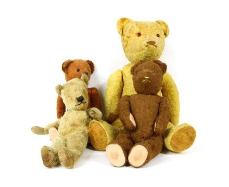 A group of four teddy bears, early to mid 20th century, mohair and articulated, a large example with two tone eyes, height 56