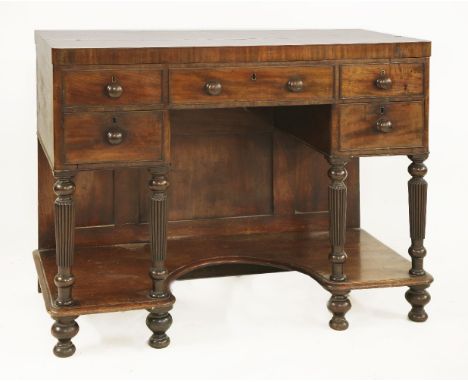 An unusual mahogany dressing table, 19th century, the hinged top enclosing a fitted interior with a hinged mirror, lidded and