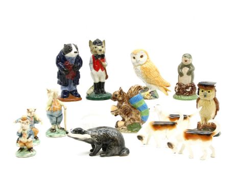 A collection of ceramic animal figures, to include Beswick hounds, a Beswick badger, a Beswick barn owl, an American carnival