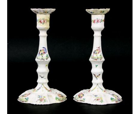 A pair of Bilston enamel candlesticks, 18th century, each decorated with exotic birds and insects and detachable drip pans, b