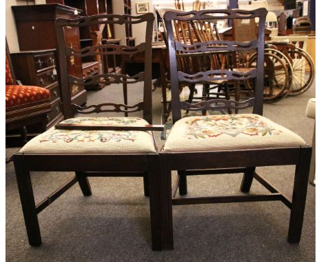 A pair of Chippendale style period single chairs, with pierced ladder backs, needlepoint drop-in seats and moulded square fro