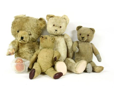 A group of four teddy bears, early to mid 20th century, a large bear with two tone plastic eyes, height 59cm, an Austrian bea