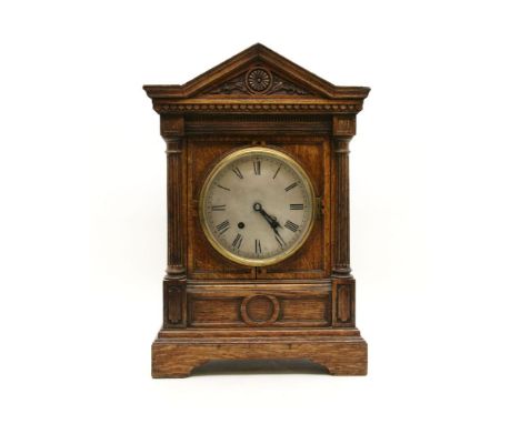 A late 19th century oak mantel clock, striking on a gong, 45cm high