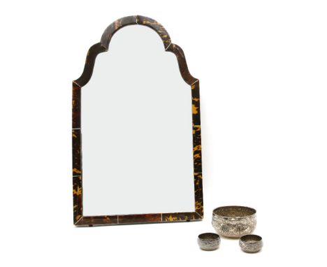 An early 20th century tortoiseshell dressing mirror, the arched plate within a tortoise shell cross section frame, together w