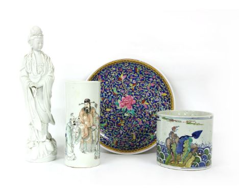 A collection of Chinese porcelain, comprising a blanc de Chine guanyin, standing on a lotus with a scroll in her hand, a brus