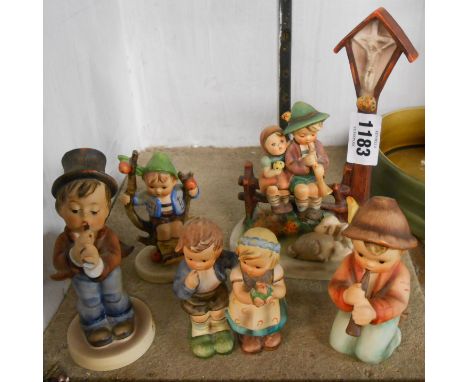 Five Hummel figurines including shepherd and cross figural group, boy in an apple tree, etc.