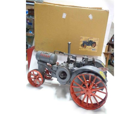 A large metal model of a Titan tractor in original box