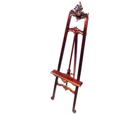 A 19th Century walnut Rococo style picture easel with pierced pediment and further pierced and carved decoration under - mino
