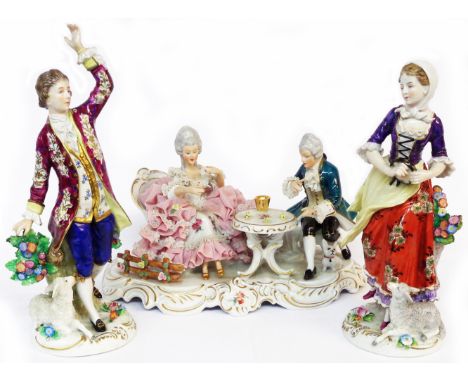 A large Dresden porcelain figure group depicting a couple in 18th Century dress playing dice at a gaming table - sold with tw