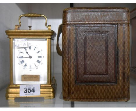 A late 19th Century gilt metal and bevelled glass cased carriage clock with Roman numerals and eight day gong striking strike