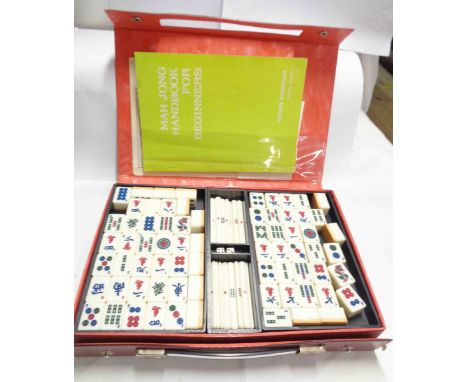 A vintage Japanese mahjong set with plastic and bamboo tiles and equipment and instruction booklet, contained in vinyl case