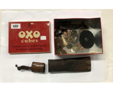 A vintage OXO tin containing a quantity of antique and later military buttons, a German patch, an old flintlock movement, etc