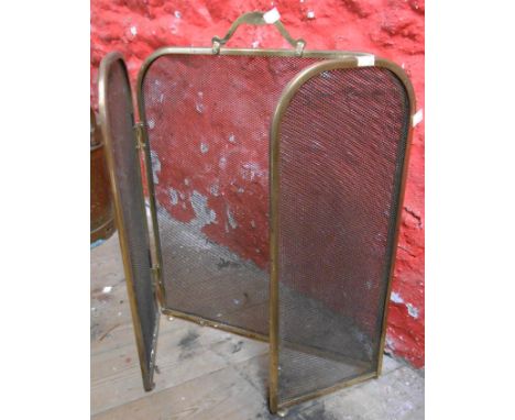 A brass framed and mesh folding firescreen