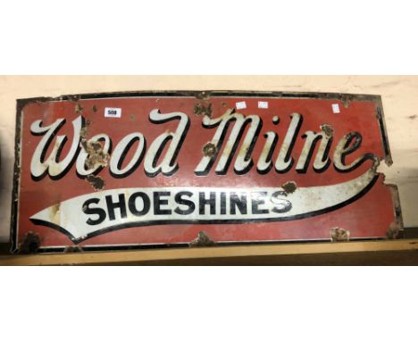 An old enamel advertising sign for Wood Milne Shoeshines with black and white lettering on a red ground - some rust