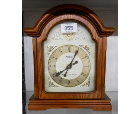 A reproduction polished wood cased break arch topped timepiece with battery movement - sold with a small Fischer sedan style 