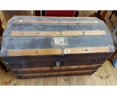 An 81cm late Victorian metal and slatted wood bound dome-top travelling trunk with flanking iron drop handles
