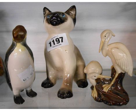 A Kensington pottery Winstanley Siamese figurine depicting a seated kitten hand painted in naturalistic colours - sold with a