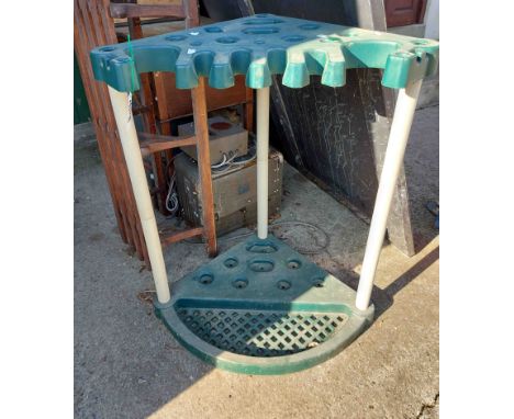 A modern plastic freestanding corner garden tool tidy