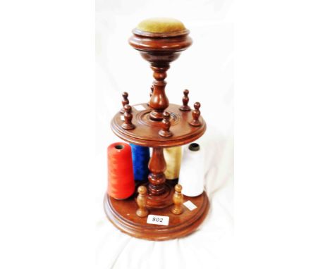 A Victorian style turned wood bobbin reel stand with inset pin cushion