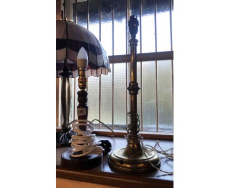 An old brass table lamp of candlestick form - sold with a smaller turned wood similar