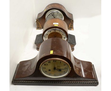 Art Deco oak cased mantel clock, the silvered chapter ring with Arabic numerals in black, within a domed case, 22cms high; to