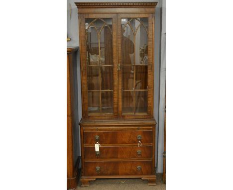 An early 20th Century mahogany display cabinet, of small proportions, with dentil cornice above two astragal glazed doors, ov