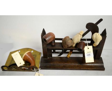 A selection of vintage tobacco pipes, including: a Turkish Meerschaum pipe carved as a man's head; a Meershaum head carved as