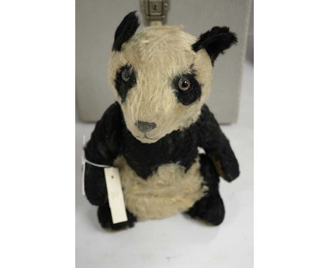 A vintage stuffed panda teddy bear, likely by Merrythought (no label present), approximately 30cms high.